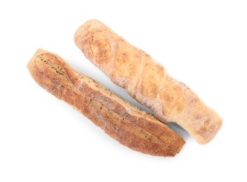 Photo of Different tasty baguettes on white background, top view. Fresh bread