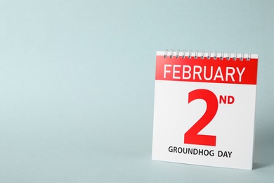 Photo of Calendar with date February 2nd on light background, space for text. Groundhog day