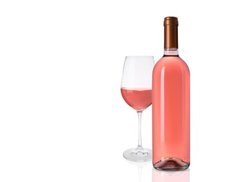 Image of Bottle and glass of delicious rose wine on white background