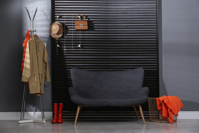 Hallway interior with sofa, clothes and accessories