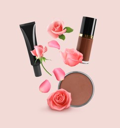 Different makeup products and beautiful roses in air on beige pink background