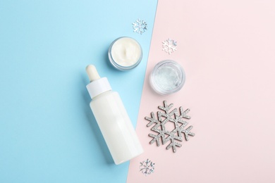 Photo of Flat lay composition with different cosmetic products on color background. Winter care