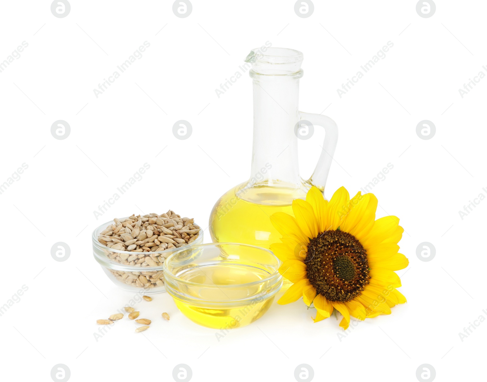 Photo of Sunflower, oil and seeds on white background