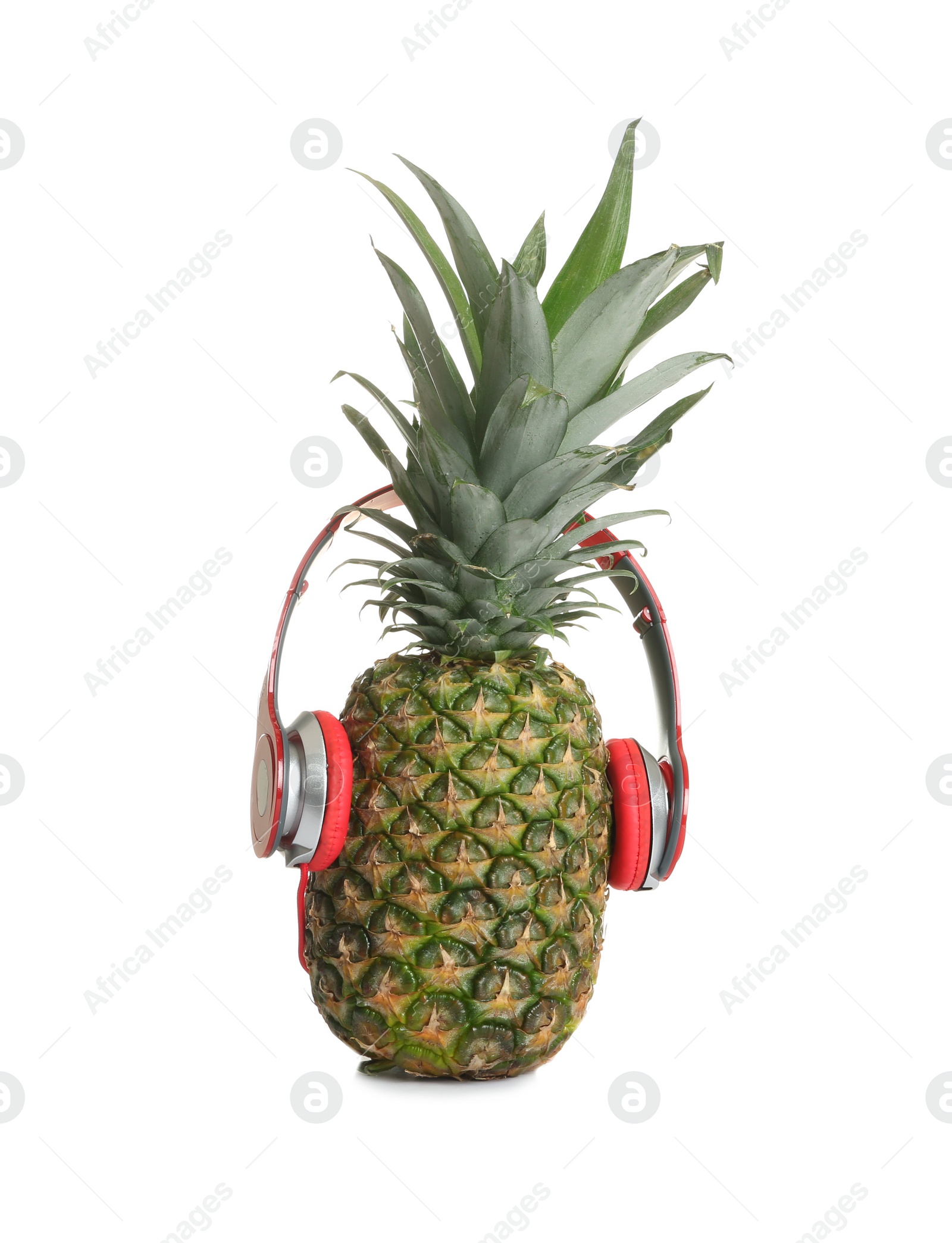 Photo of Funny pineapple with headphones on white background