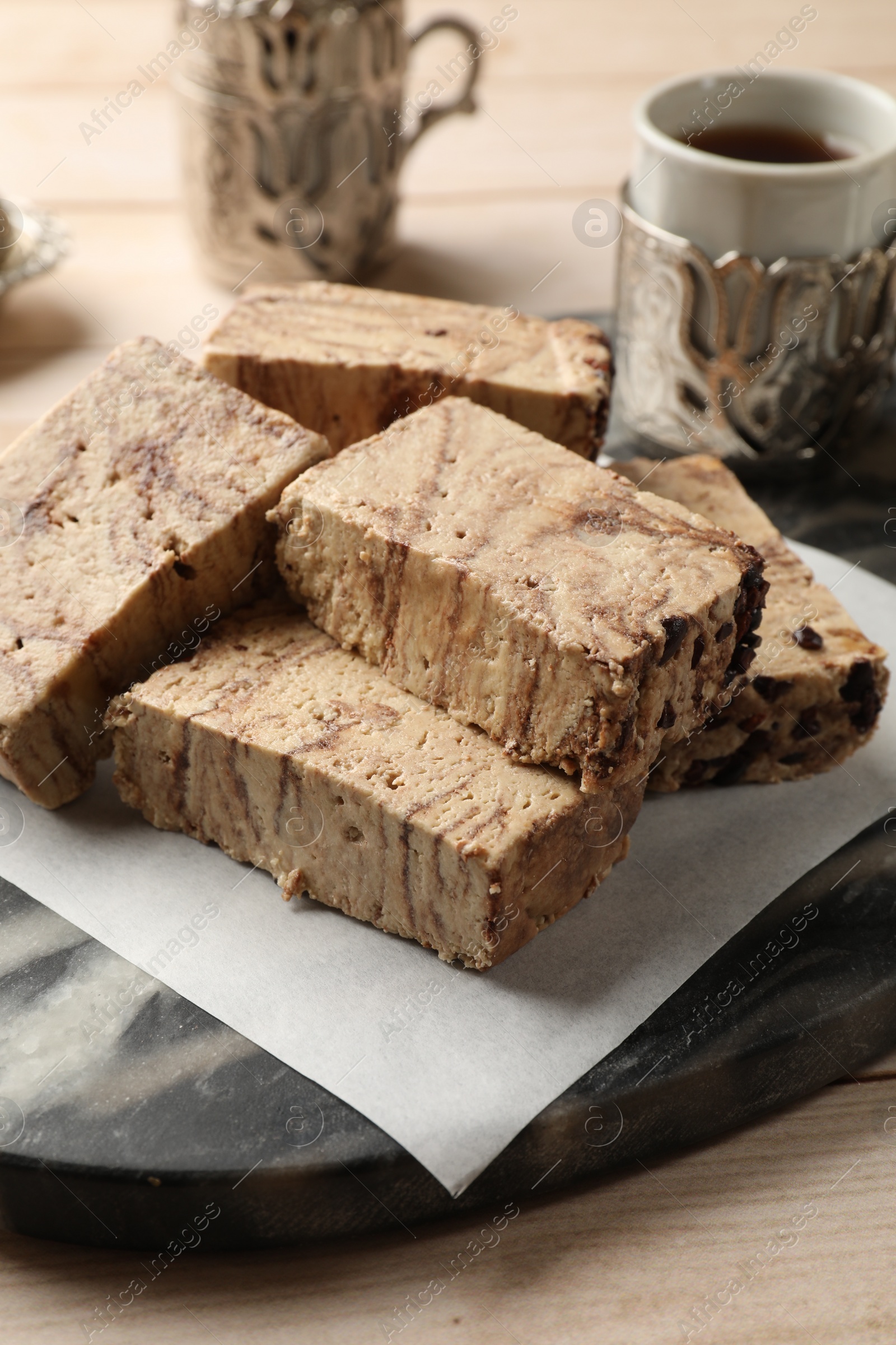 Photo of Tasty chocolate halva on wooden table, closeup