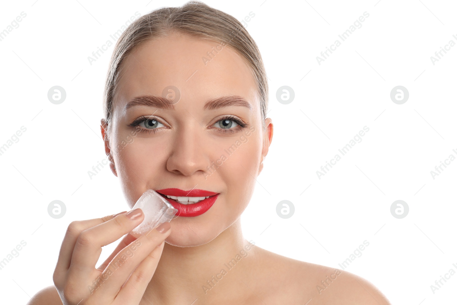 Photo of Young woman with ice cube on white background. Skin care