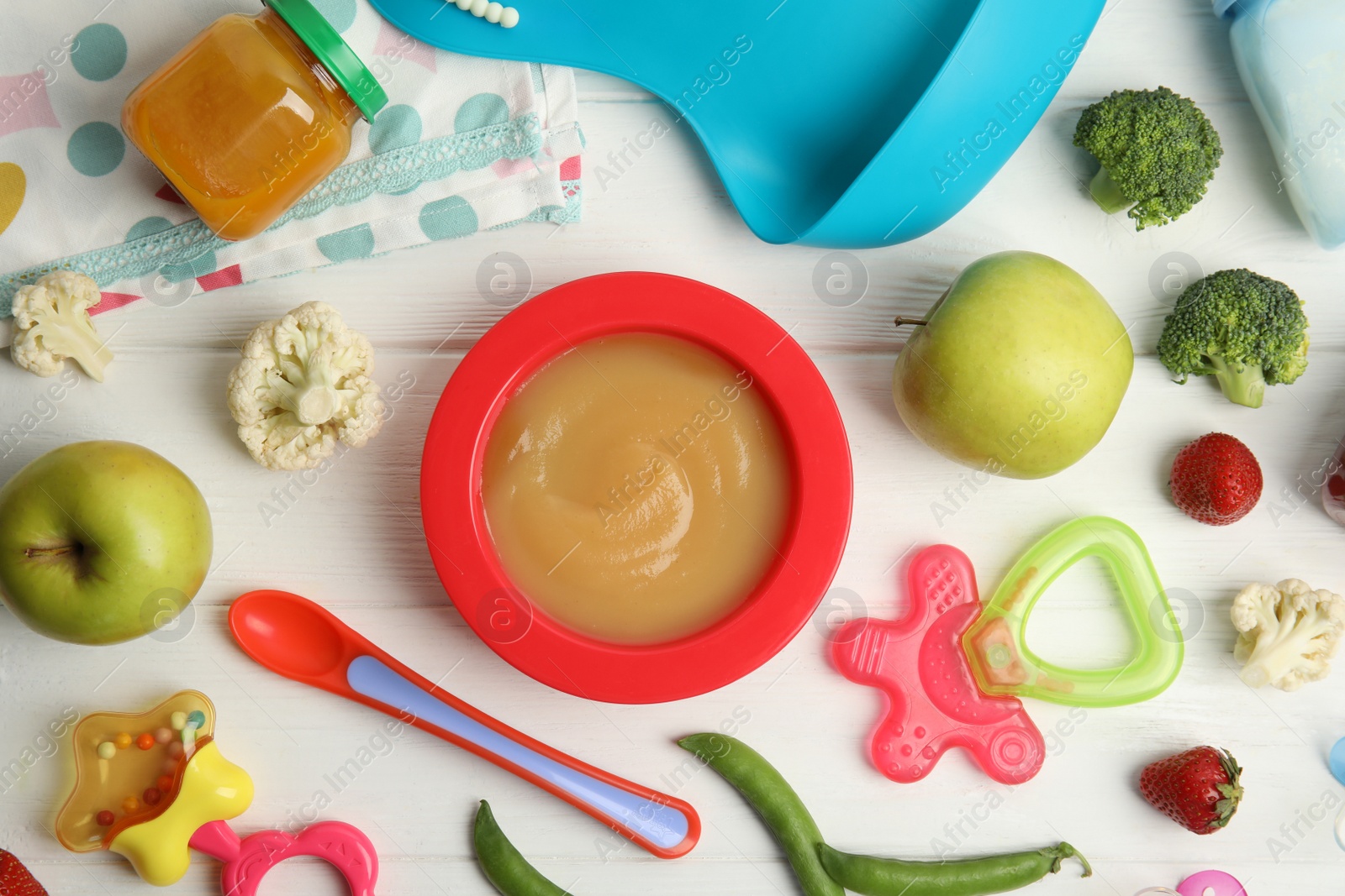 Photo of Flat lay composition with healthy baby food, ingredients and accessories on white wooden table