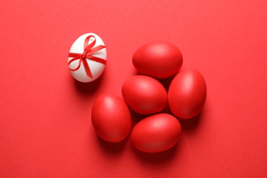 Photo of Flat lay composition of dyed Easter eggs on color background