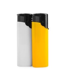 Stylish small pocket lighters on white background