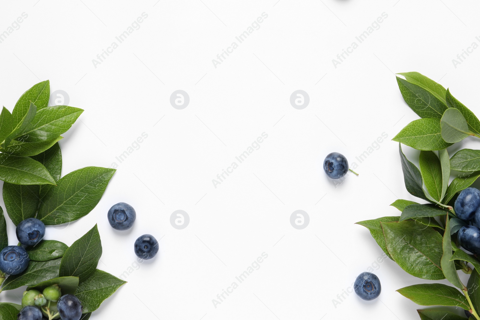 Photo of Tasty fresh blueberries with green leaves on white background, flat lay. Space for text