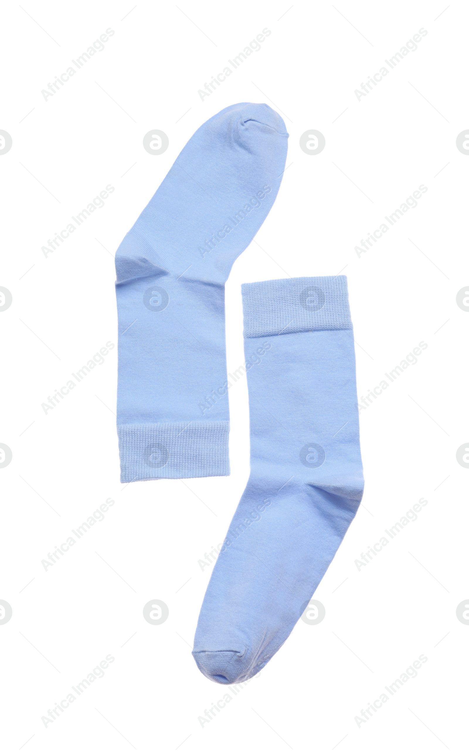 Photo of Light blue socks on white background, top view