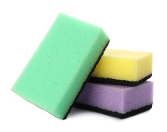 Photo of Bright cleaning sponges with abrasive scourers on white background