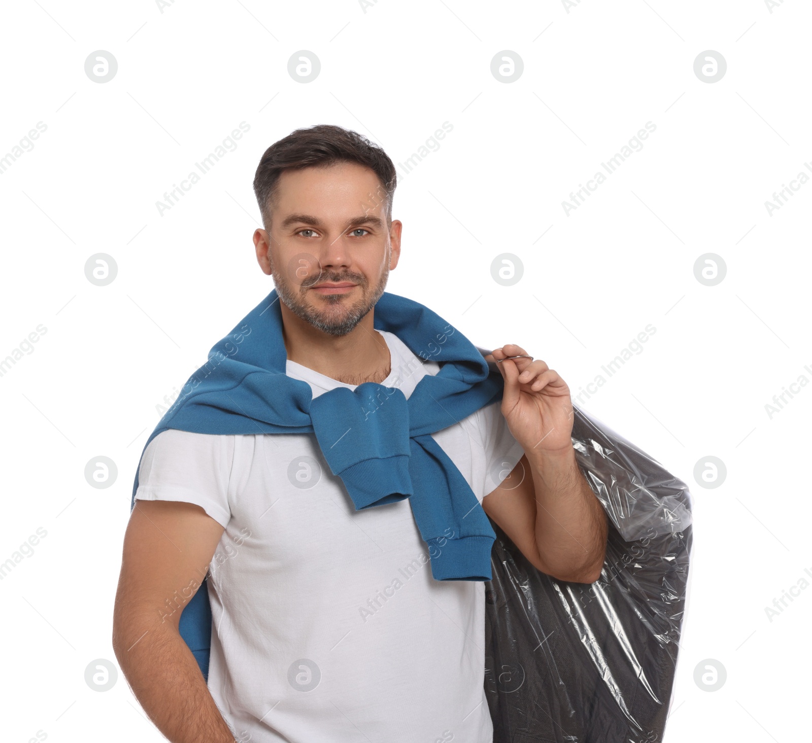 Photo of Man holding garment cover with clothes on white background. Dry-cleaning service