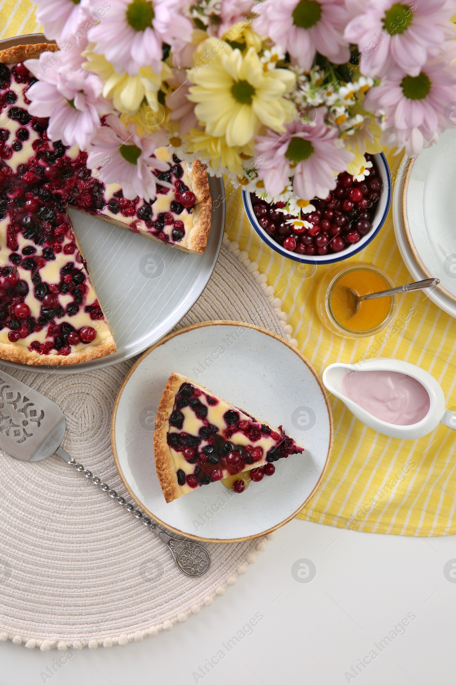 Photo of Delicious currant pie and fresh berries on white table, flat lay