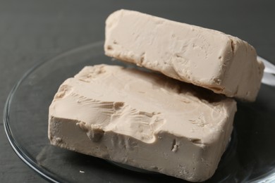 Photo of Compressed yeast on grey wooden table, closeup