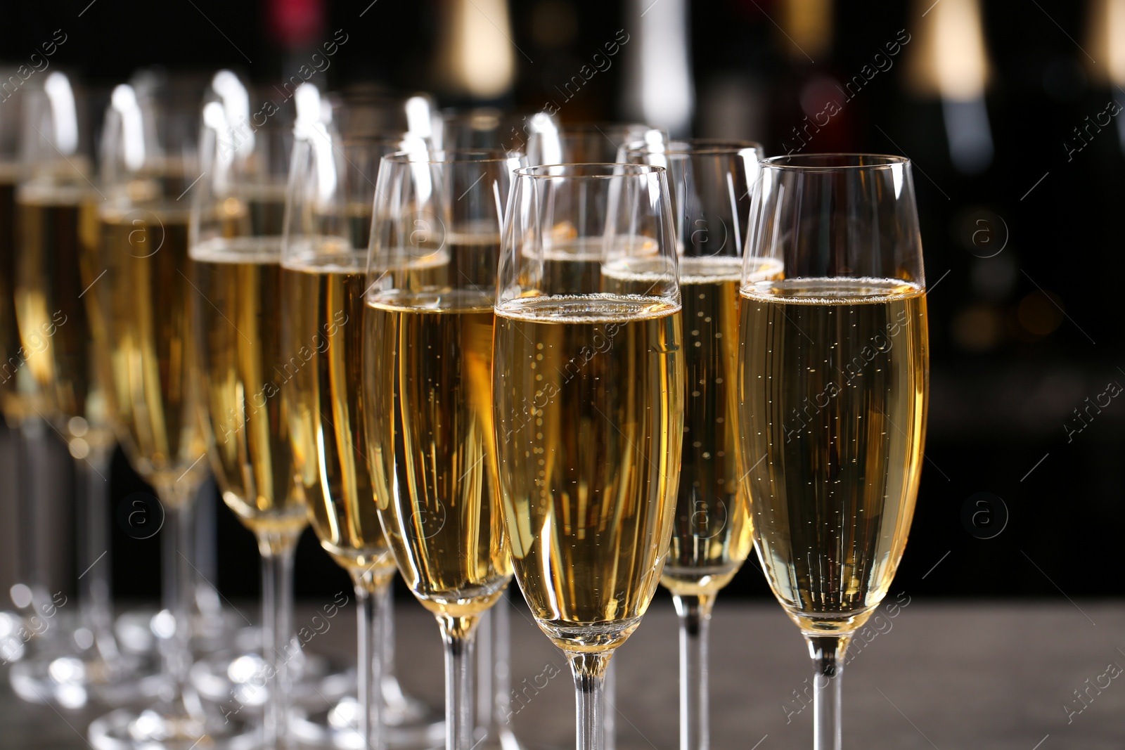 Photo of Many glasses of champagne on blurred background, closeup