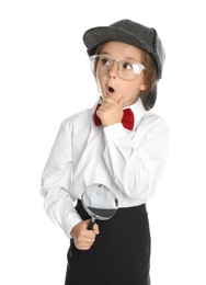 Photo of Cute little child in hat with magnifying glass playing detective on white background