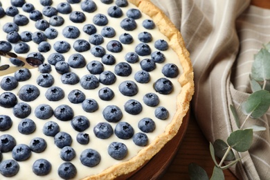 Tasty cake with blueberry on table, closeup