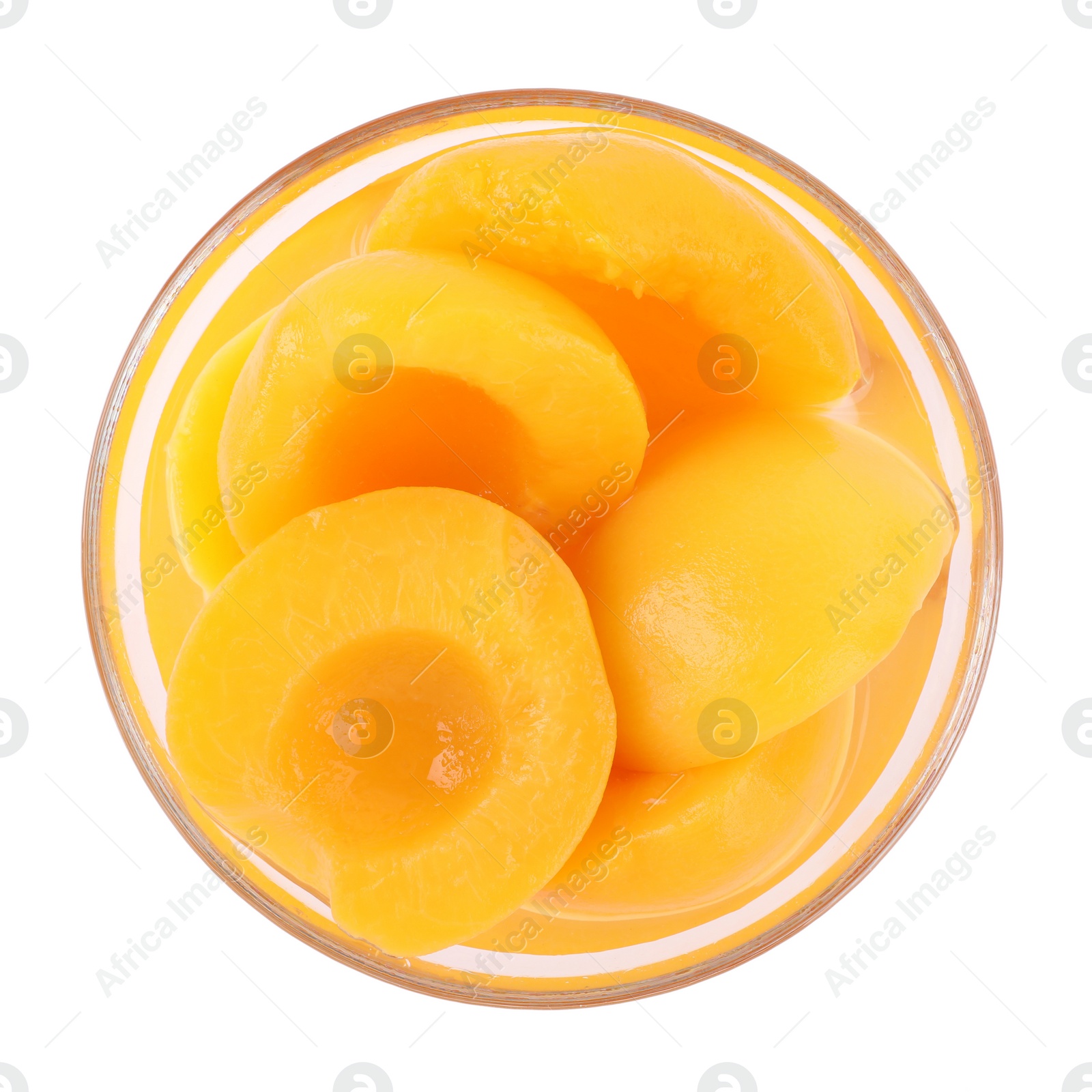 Photo of Halves of canned peaches in bowl isolated on white, top view