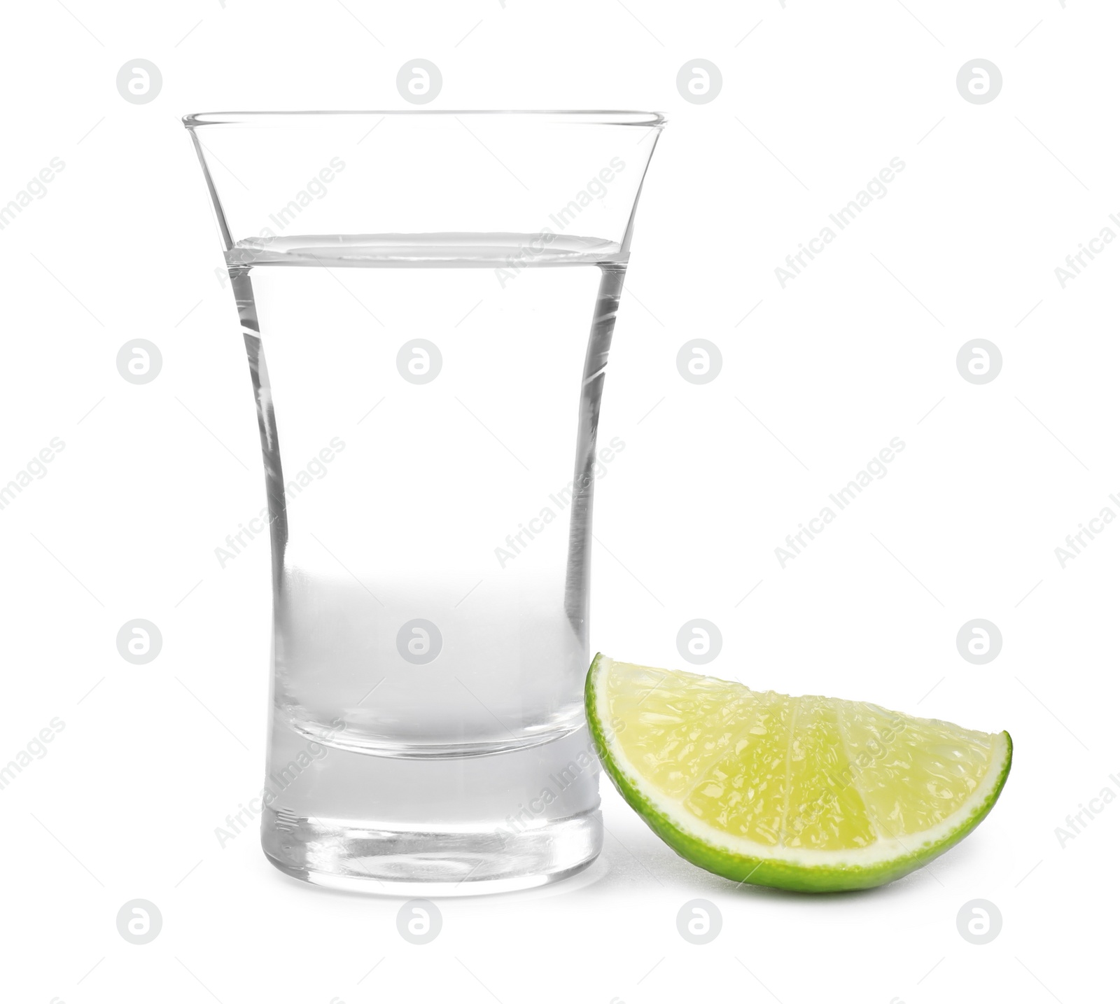 Photo of Mexican Tequila shot with lime slice isolated on white