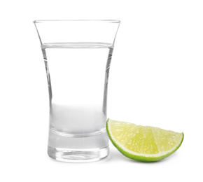 Photo of Mexican Tequila shot with lime slice isolated on white
