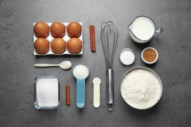 Photo of Flat lay composition with fresh ingredients for delicious homemade cake on grey table