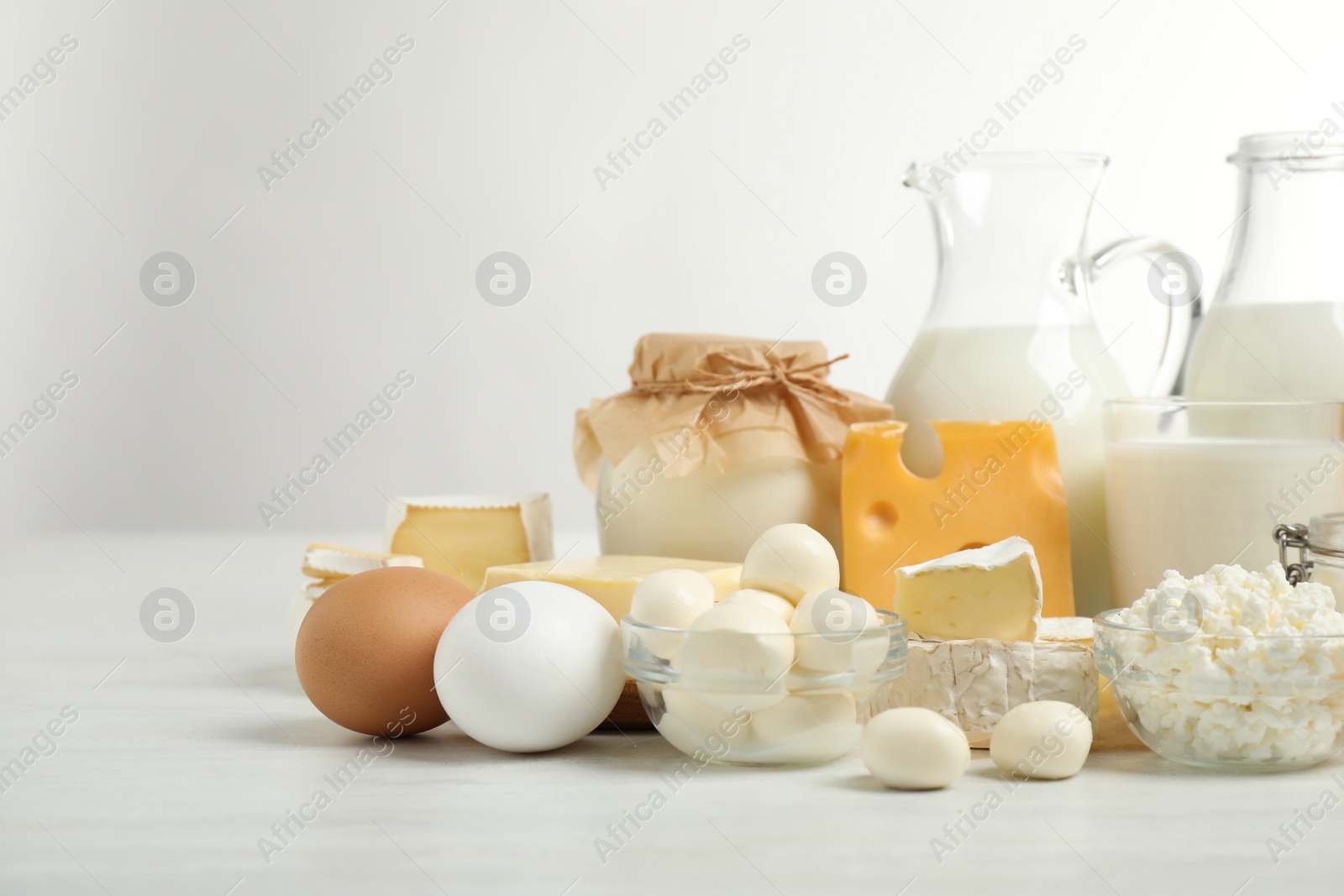 Photo of Different delicious dairy products on white table