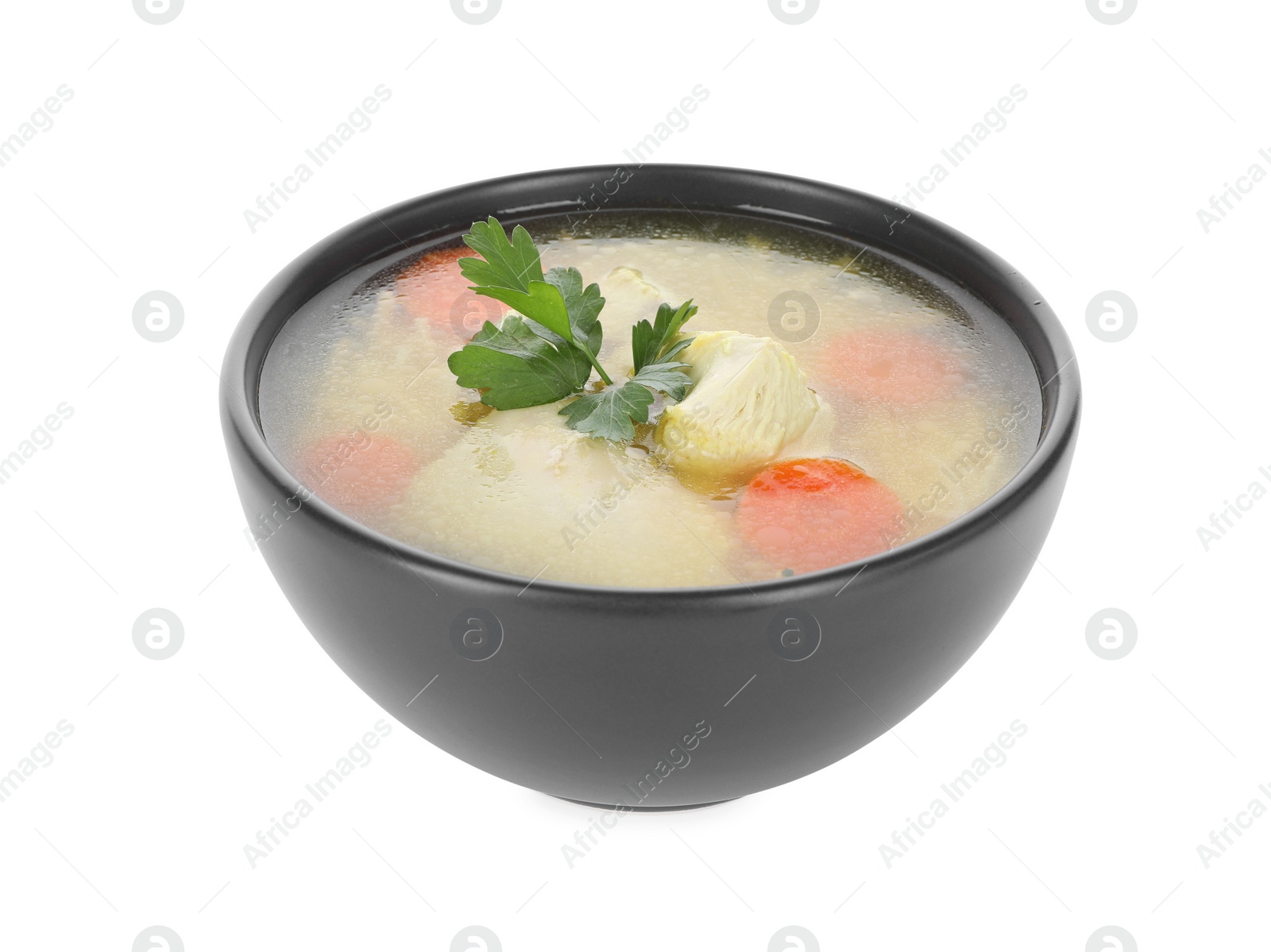 Photo of Tasty chicken soup with carrot and parsley in bowl isolated on white