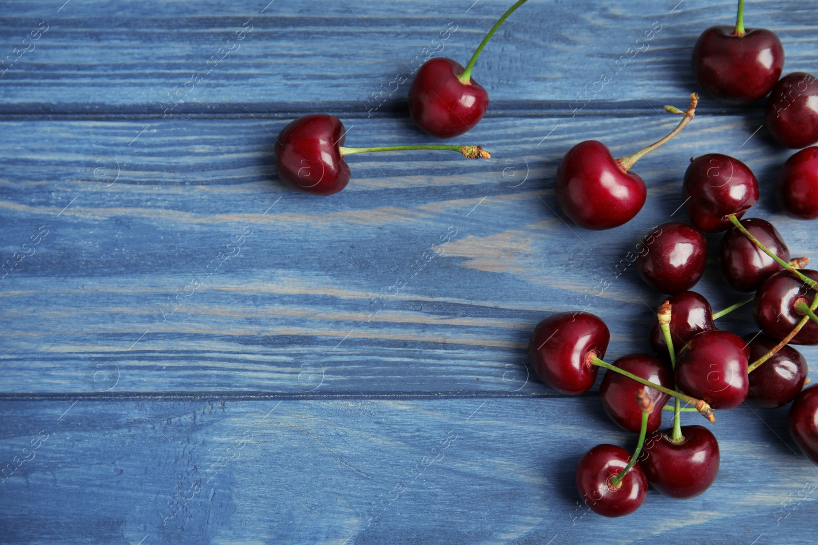 Photo of Sweet red cherries on wooden table, top view