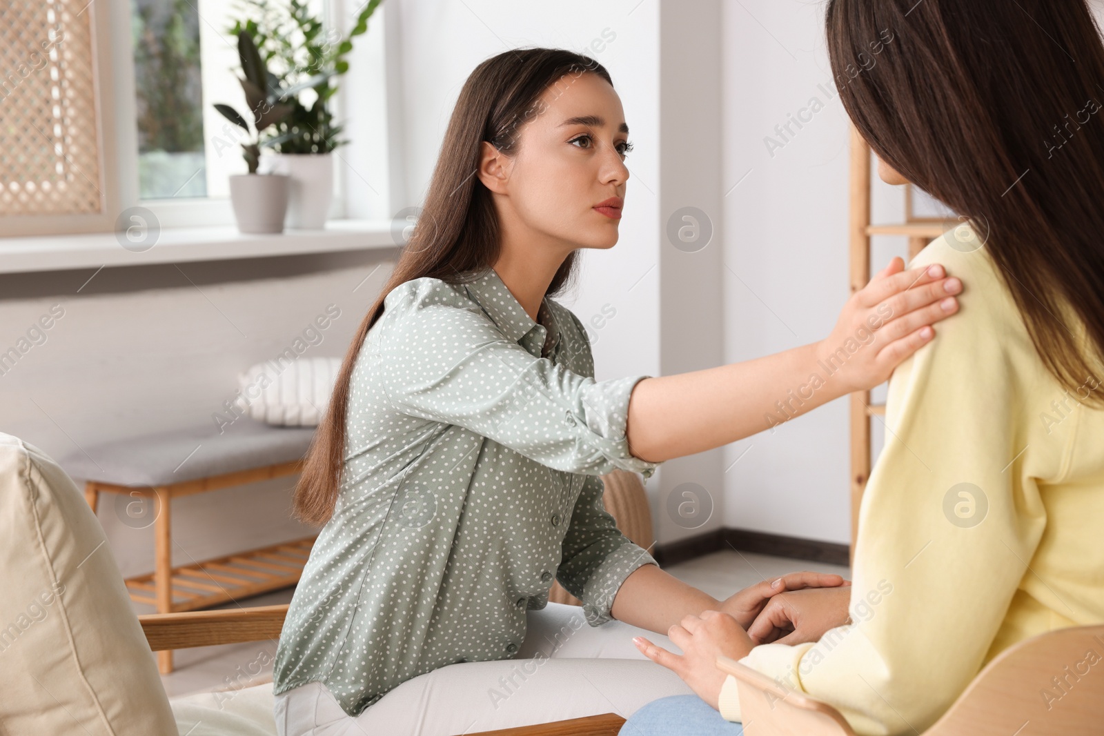Photo of Professional psychologist working with young woman in office