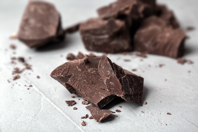 Photo of Delicious dark chocolate on grey background, closeup