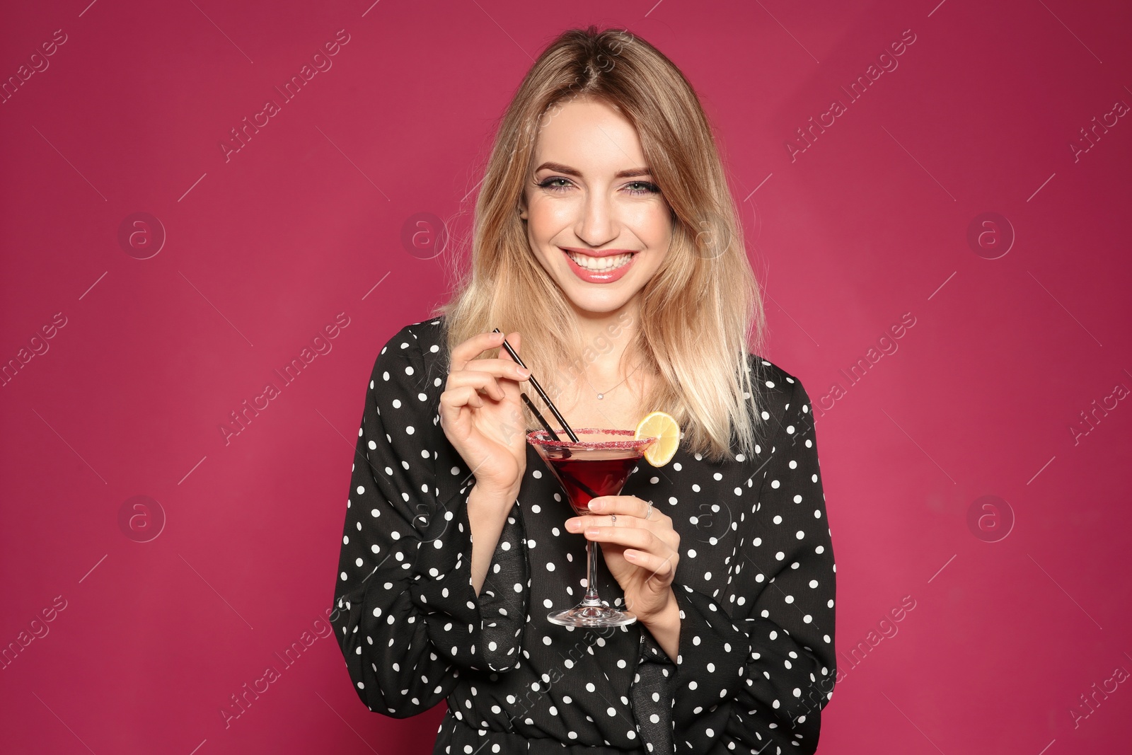 Photo of Beautiful young woman with glass of martini cocktail on color background