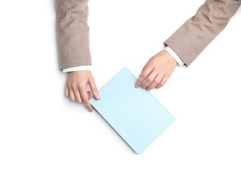 Photo of Woman with notebook on white background, top view. Closeup of hands