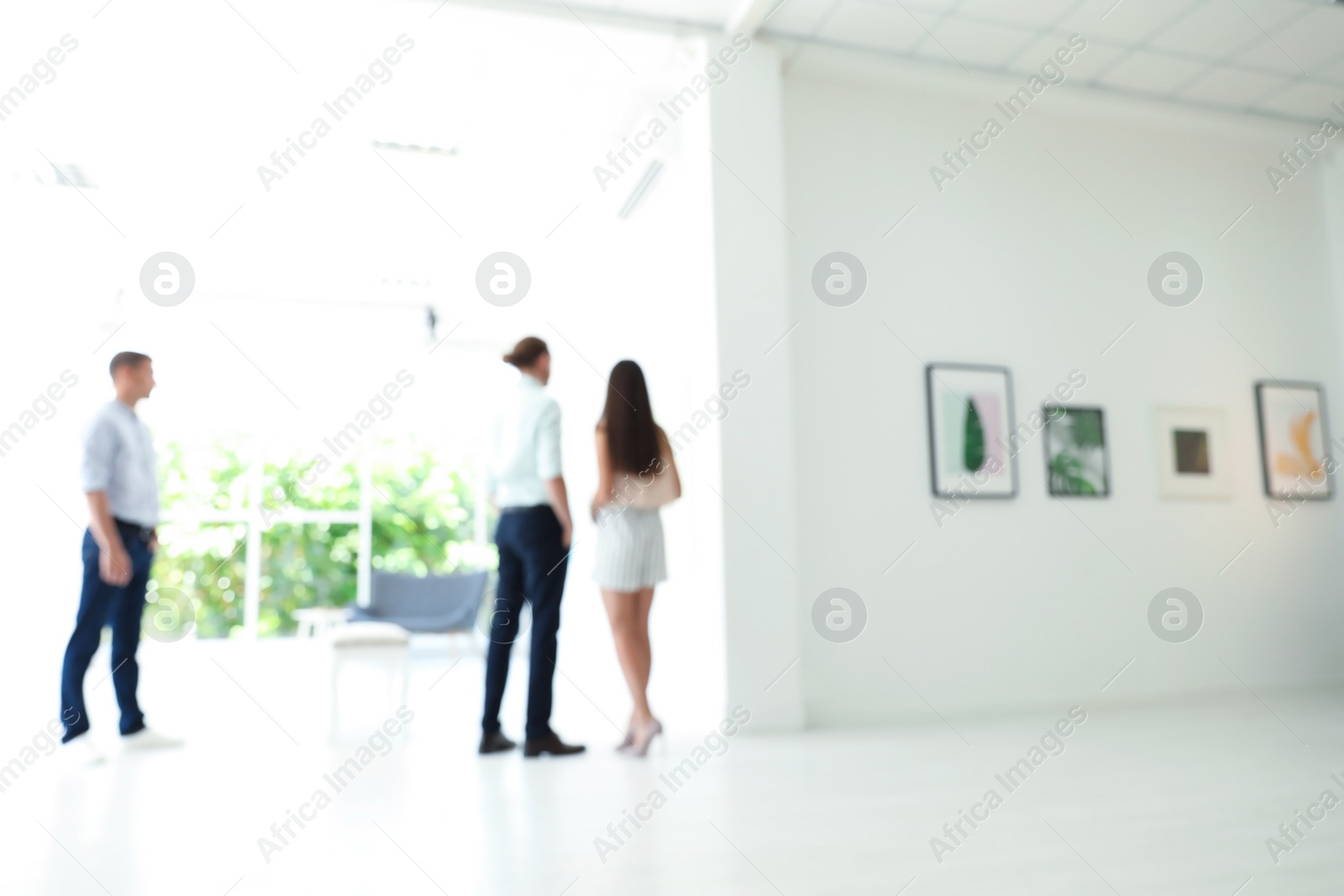 Photo of Blurred view of people at exhibition in art gallery