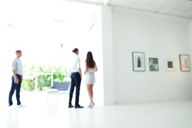 Blurred view of people at exhibition in art gallery