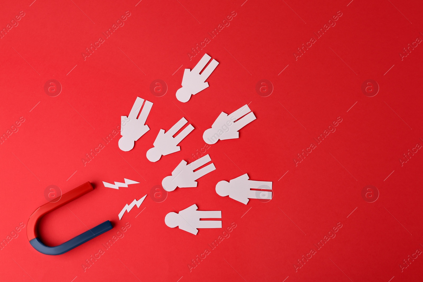 Photo of Magnet and paper people on red background, flat lay