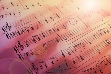 Sheet with music notes as background, closeup. Bokeh and color tone effects