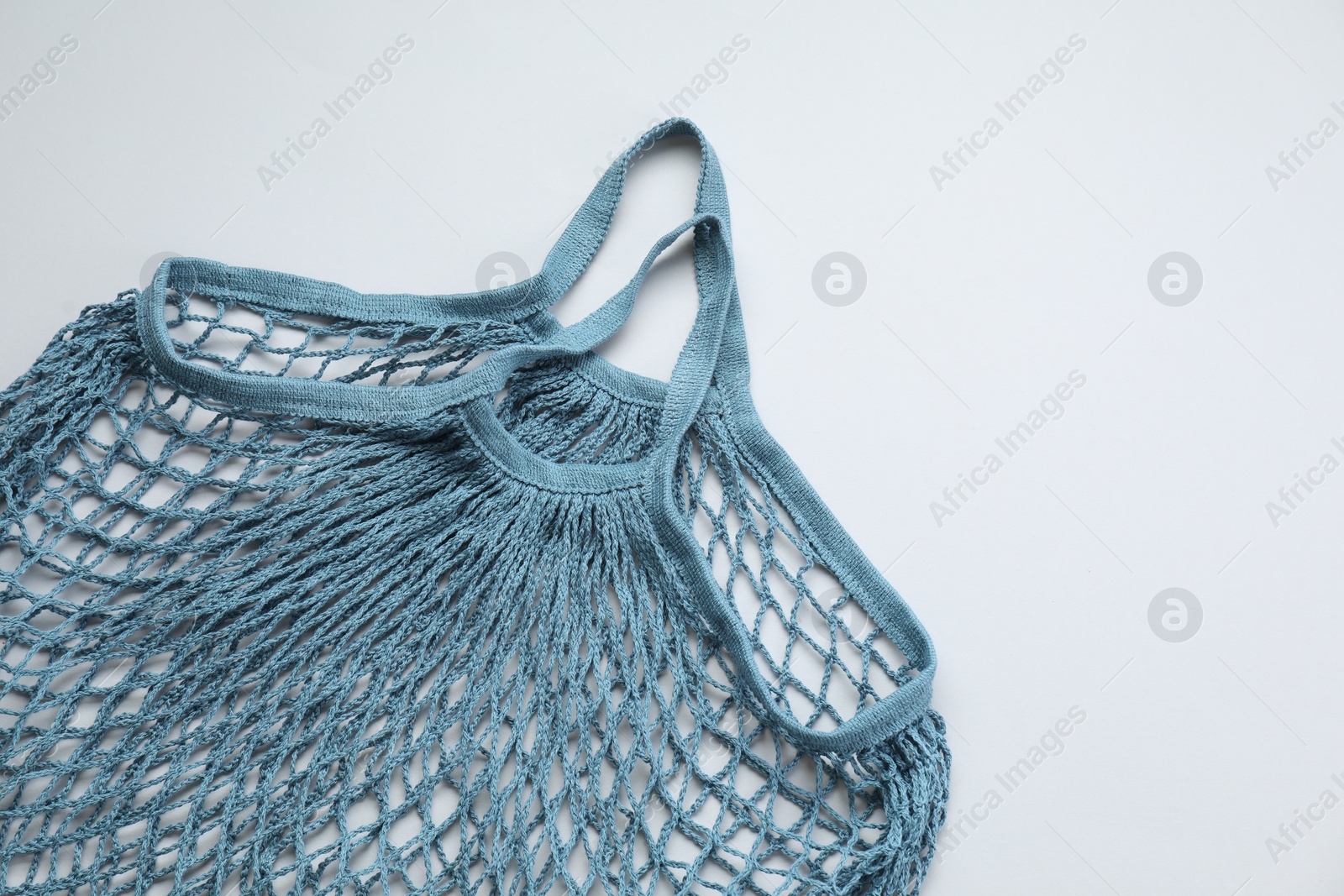 Photo of Blue string bag on light grey background, top view