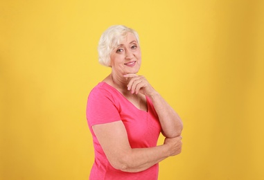 Photo of Senior woman in casual outfit on yellow background