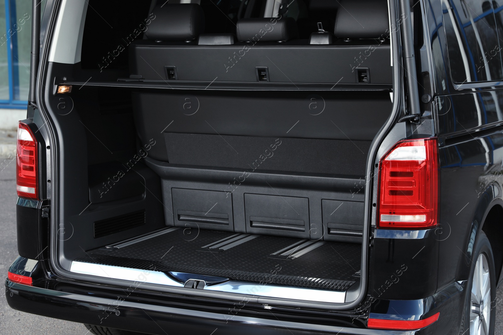 Photo of Modern car with open empty trunk outdoors