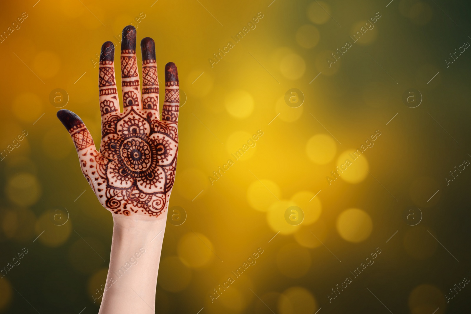 Image of Woman with henna tattoo on hand against blurred lights, bokeh effect. Space for text