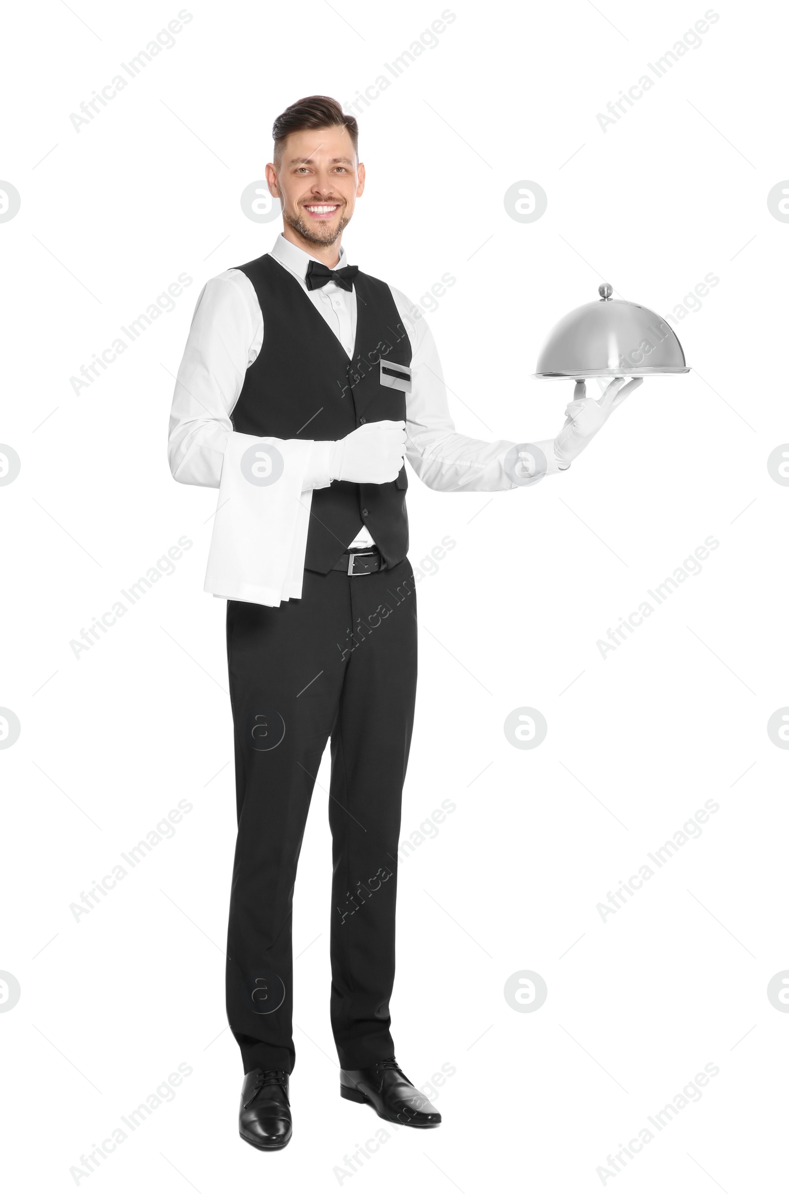 Photo of Handsome waiter holding metal tray with lid on white background