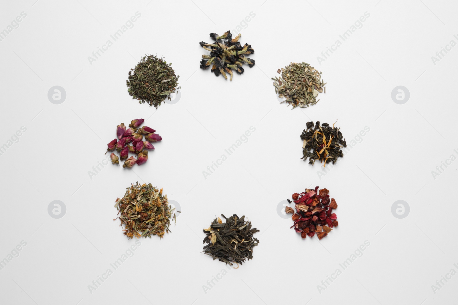 Photo of Frame of different dry teas on white background, top view