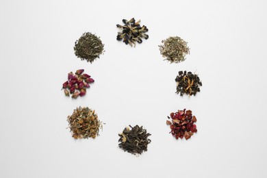 Photo of Frame of different dry teas on white background, top view