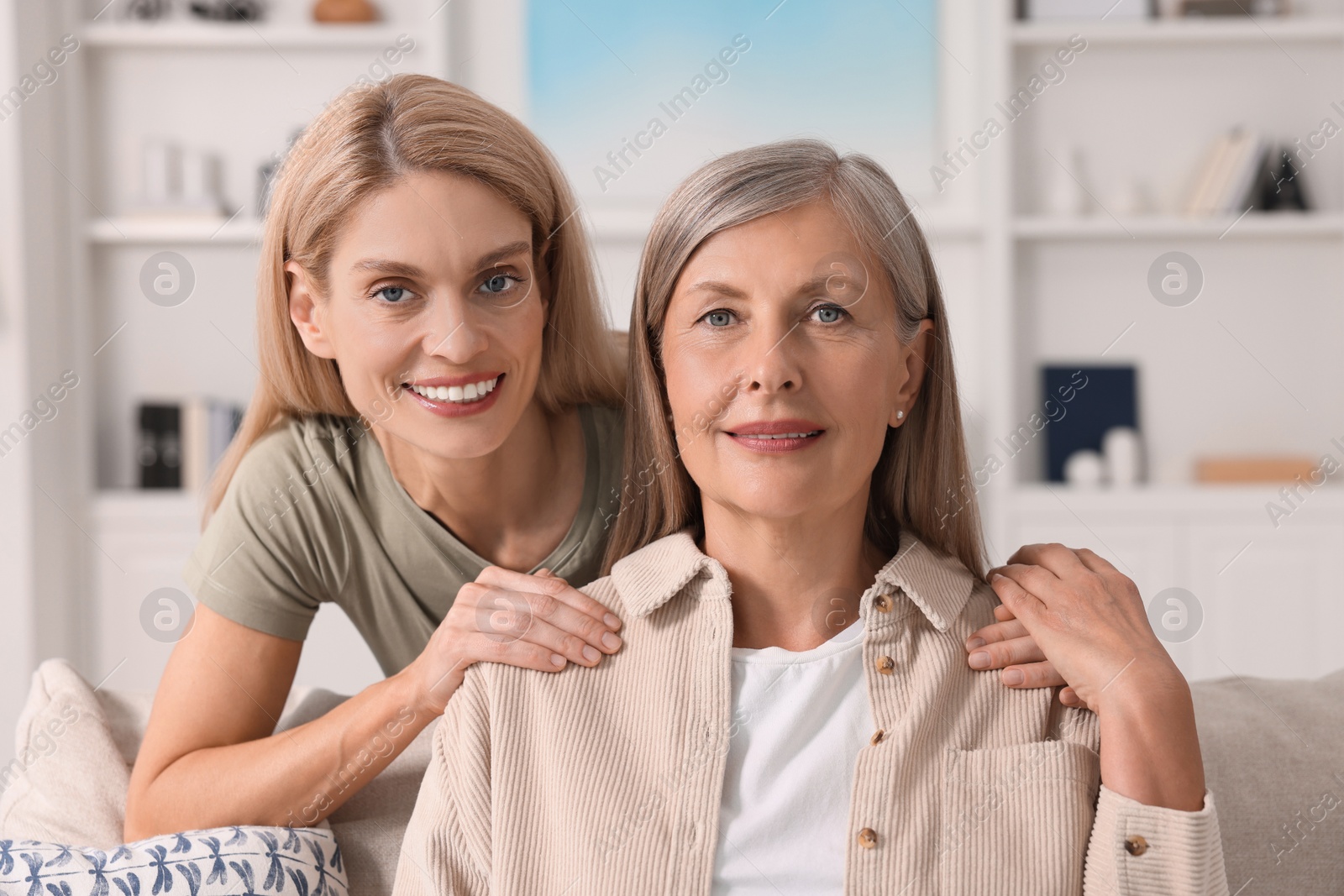 Photo of Happy mature mother and her daughter at home