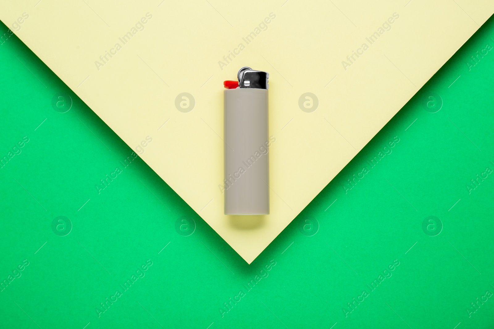 Photo of Stylish small pocket lighter on color background, top view