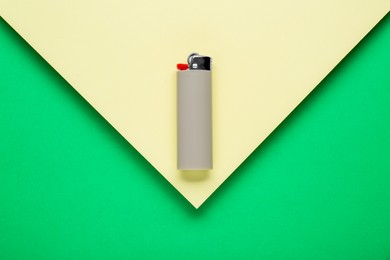 Stylish small pocket lighter on color background, top view