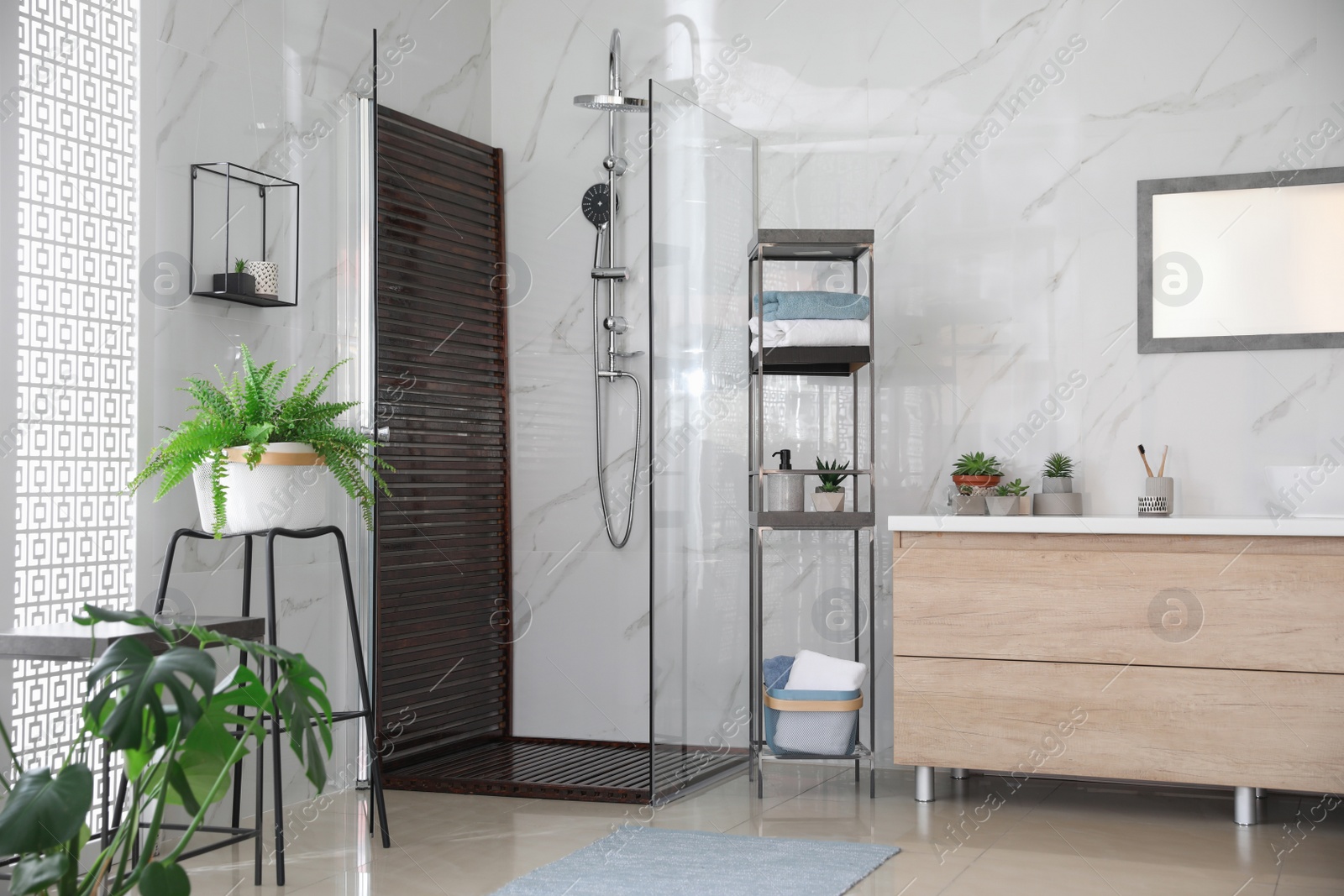 Photo of Bathroom interior with shower stall, counter and houseplants. Idea for design