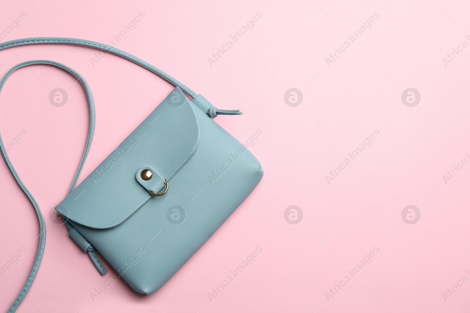 Photo of Stylish woman's bag on pink background, top view. Space for text