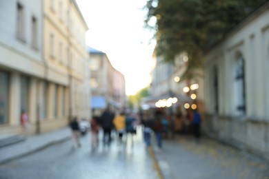 Photo of Blurred view of people walking on city street